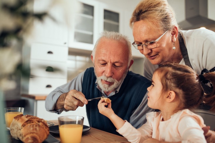 Grandparents at table with grandchild